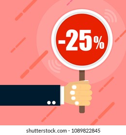 the hand holds a sign on which is written -25% on the red background