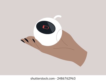 A hand holds a small, white robot with a red battery indicator showing it is empty, The device appears to be asleep