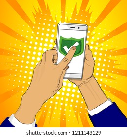 Hand holds smart phone with green shield and a finger touches the screen. Cartoon pop art retro vector illustration drawing in comic book style.