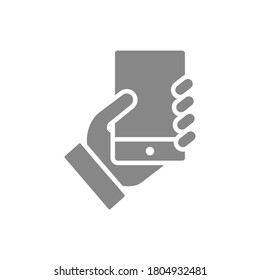 Hand holds a smarthone grey icon. Social network activitiy, blogging, feedback sign