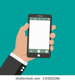 Hand holds smartphone with camera on smartphone screen. Multimedia, photo album app concept. 