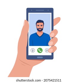 Hand holds smartphone during video call. Young man on smartphone screen with connection icons. Communication online using the phone. Talking through video call. Chatting online. Vector illustration