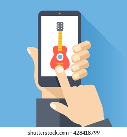 Hand holds smartphone with guitar icon on smartphone screen. Listening to music, DAW, audio software. Modern simple flat design for web banners, web site, infographics. Creative vector illustration
