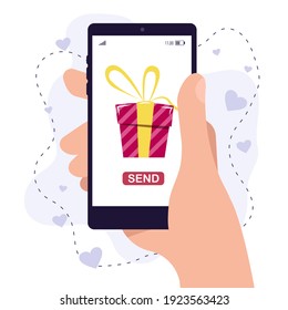 Hand holds a smartphone, while sending a gift. Online shopping gifts. Screen with present