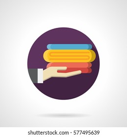 Hand holds a stack of colorful towels. Round flat style icon