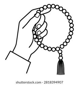 A hand holds a string of prayer beads with a tassel, symbolizing faith and spirituality