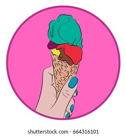 Hand holds a waffle cone with a colorful balls of an ice cream