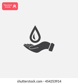 Hand holds water drop symbol. 