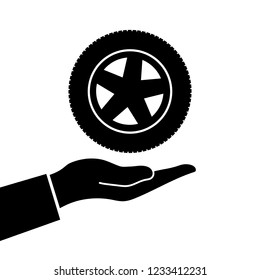 Hand holds wheel. Vector illustration. Silhouette in white background