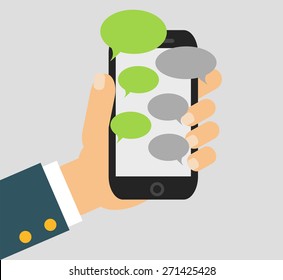 Hand Holing Black Smartphone Similar To Iphon With Blank Speech Bubbles For Text. Text Messaging Flat Design Concept. Eps 10 Vector Illustration