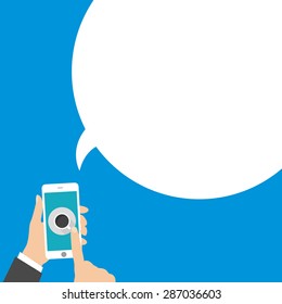 Hand holing smartphone with blank speech bubble for text