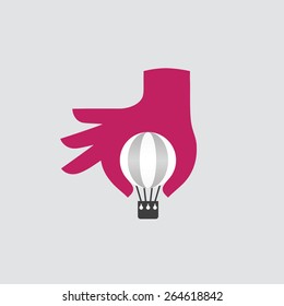 Hand with hot air balloon. Creative concept.