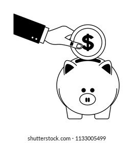 Hand inserting coin to piggy black and white