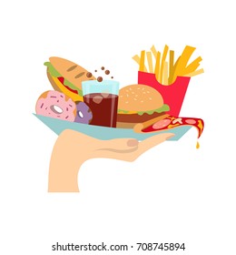 Hand with junk food. Hand holding burger with donut, cola and more.