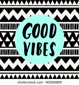 Hand lettered inspirational quote "Good Vibes Only", neon blue colored circle, tribal geometric pattern background. Modern greeting card, poster, t-shirt design.