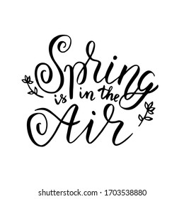 Hand lettered inspirational quote 'Spring is in the air'. Hand brushed ink lettering. Modern brush calligraphy. Handwritten phrase for card or poster. Vector illustration.