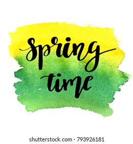 Hand lettered style spring design on a green and yellow watercolor painted background. Spring Time hand drawn calligraphy letters.