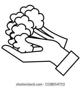 hand lifting fresh broccoli