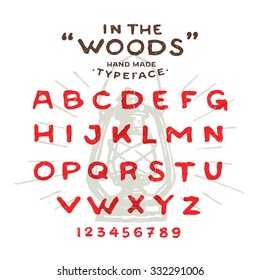 Hand Made rustic typeface 'In The Woods' Custom handwritten alphabet. Hand drawn Letters and Numbers. Vintage retro textured font grunge effect. Background Lantern Vector illustration with sun rays.