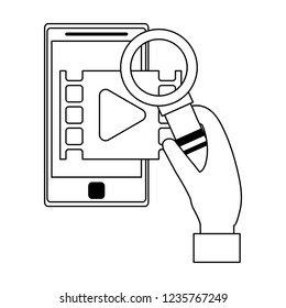 Hand with magnifying glass checking video on smartphone black and white
