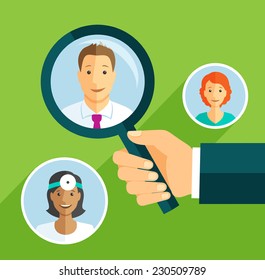 Hand with magnifying glass focused on selecting doctor