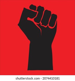 The hand making fist with red background. The concept of strength , revolution and freedom 