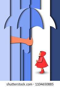 Hand man holding an umbrella over a girl in a raincoat