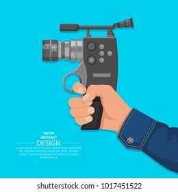 The hand of the man holds the video camera.Design elements. A vector illustration in flat style.