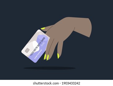 A hand with neon manicure holding a plastic credit card, online shopping, millennial lifestyle