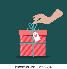 A hand opens a gift with a greeting card. Vector illustration.