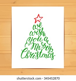 Hand painted brush lettering We wish you a Merry Christmas. Calligraphy inscription inside the fir tree. Vector hand drawn typography. 