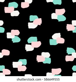 Hand painted brush strokes in white, turquoise green and pastel pink on black background. Seamless abstract repeating background.