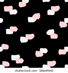 Hand painted brush strokes in white and pastel pink on black background. Seamless abstract repeating background.