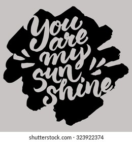 Hand painted quote 'You are my sunshine'. Vector brush lettering on grunge black ink spot.
