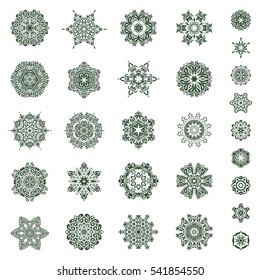Hand painted sketch. Vector set of abstract hand drawn green snowflakes maked on a white background.