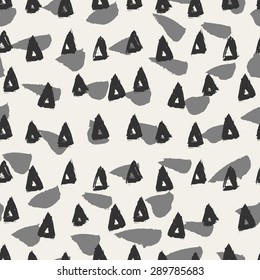 Hand painted triangles and brush strokes in light and dark gray. Seamless abstract repeating hand drawn background.