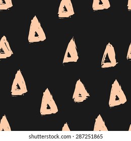 Hand painted triangles in pastel orange on black background. Seamless geometric repeating background.
