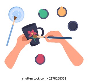 Hand paints a ceramic mug with paints. There are jars of paint, a glass of water and a brush nearby. Hobby. Top view. Vector illustration in flat style on a white background