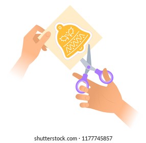 Hand with a pair of scissors cuts out a christmas jingle bell from paper. Flat vector illustration of jingle bell shape with dotted line and school shears. The xmas celebration and decoration concept.