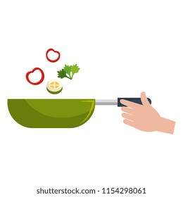 hand with pan cooking vegetables