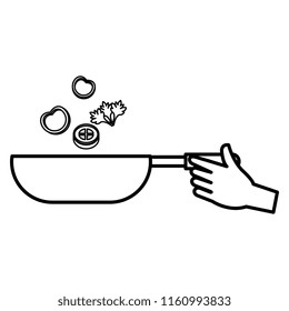 hand with pan cooking vegetables