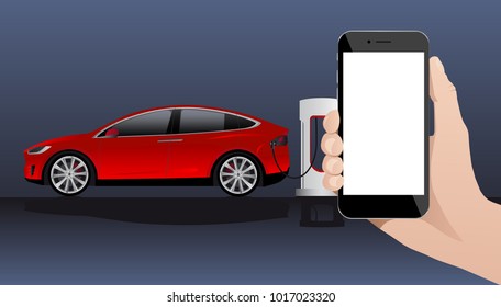 Hand with phone on a background of electric car charging point.