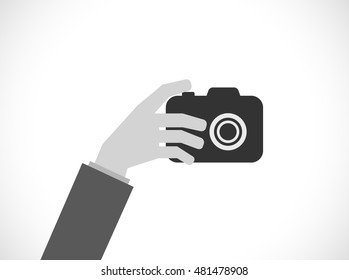 mano con cámara fotográfica - icono plano