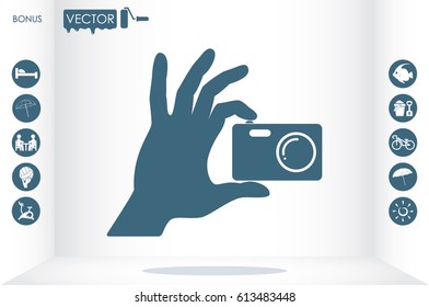 Hand and photo camera icon vector