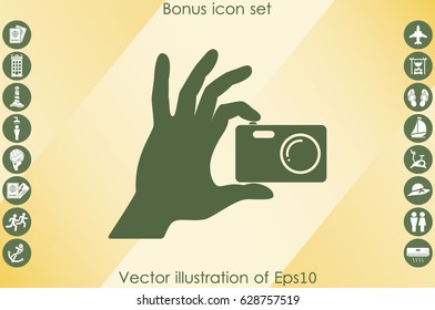 Hand and photo camera icon vector