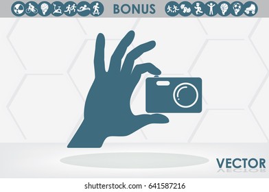 Hand and photo camera icon vector