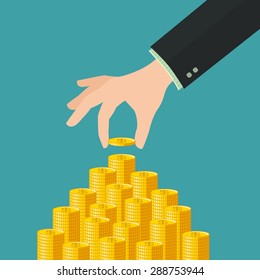 Hand placing a coin on money stack
