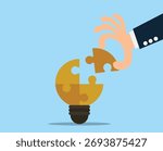 hand placing the final puzzle piece into a light bulb. Businessman with puzzles bulb idea