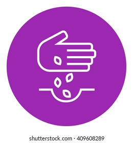 Hand planting seeds in ground line icon.
