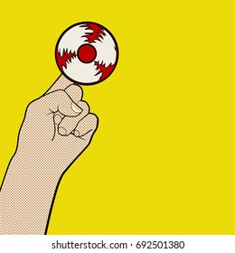 Hand playing popular finger spinner toy in pop art style. Vector illustration.